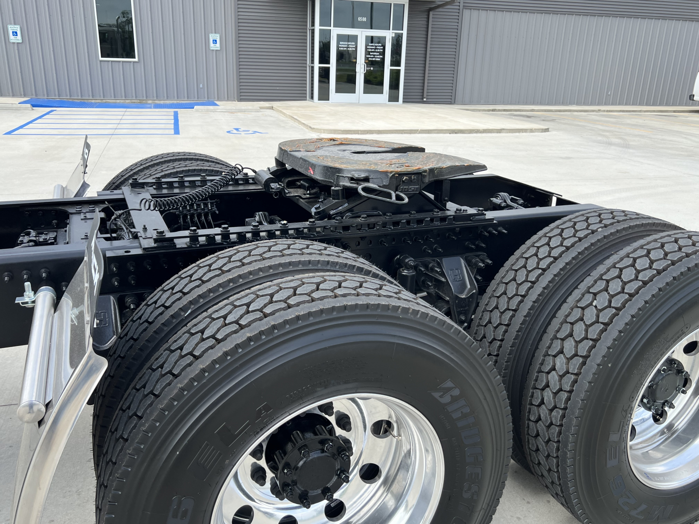 Mack PI64T truck chassis showing rear dual rear axles with dual tires and fifth-wheel mounting plate.