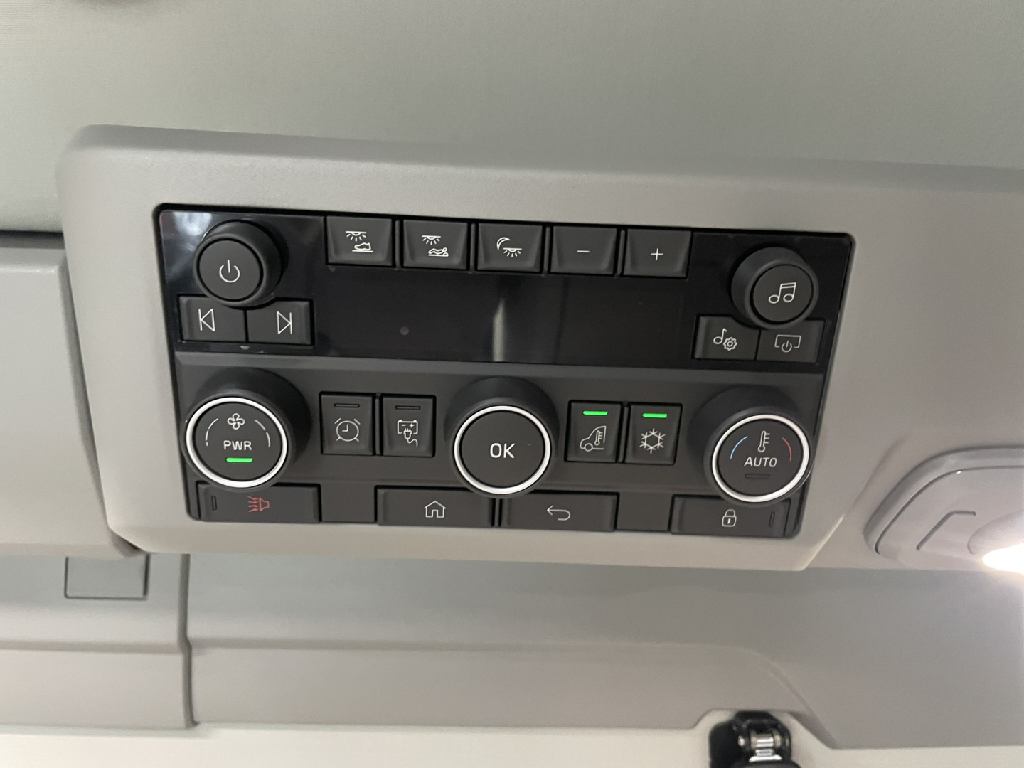 Volvo VNL64T860 control panel image showing various buttons and knobs in-center dash area.