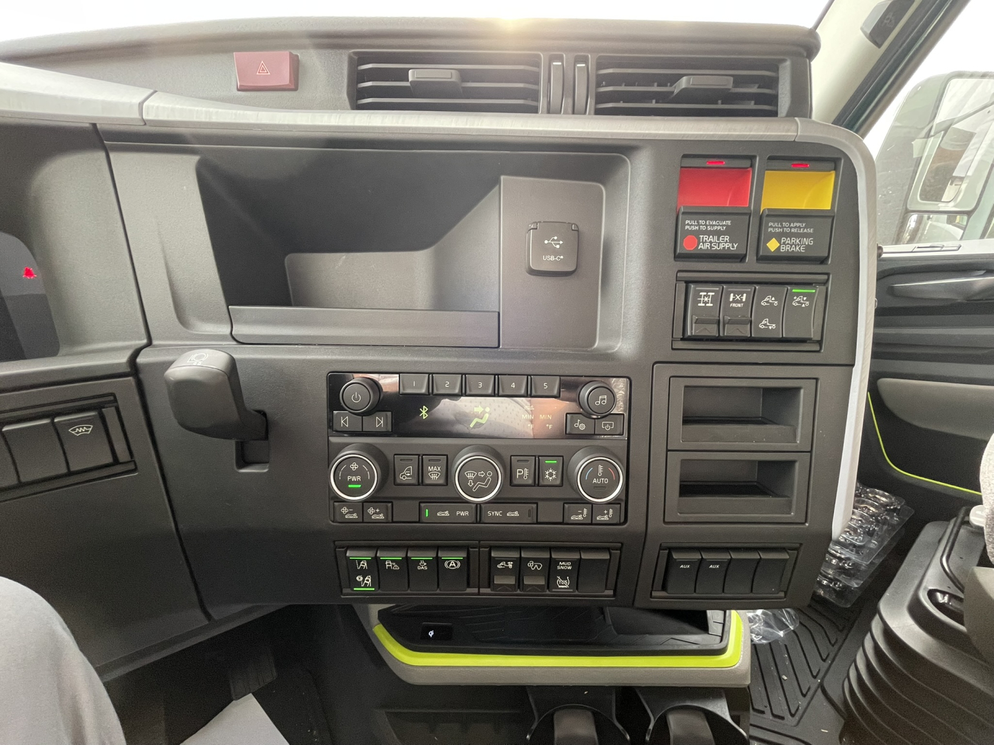 Volvo VNL64T860 dashboard and center console showing control panel with vents, switches, and digital display.