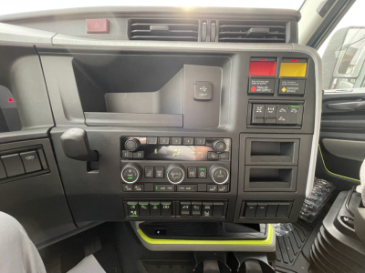 Volvo VNL64T860 dashboard and center console showing control panel with vents, switches, and digital display.