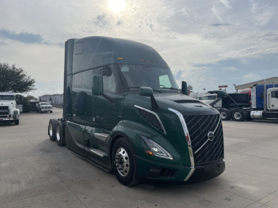Volvo VNL64T860 truck front-left view showing large grille, aerodynamic mirrors, and sleeper cab.