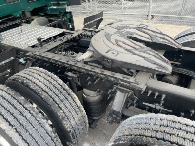 Volvo VNL tractor tandem rear showing fifth wheel and chassis components with dual rear axles and air/electrical lines.