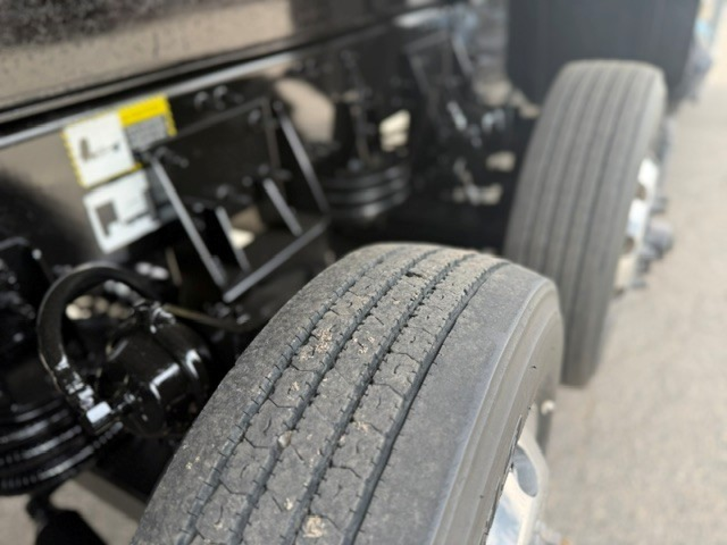 Truck chassis and dual rear axles with tires; Mack GR64F vibe, undercarriage visible.