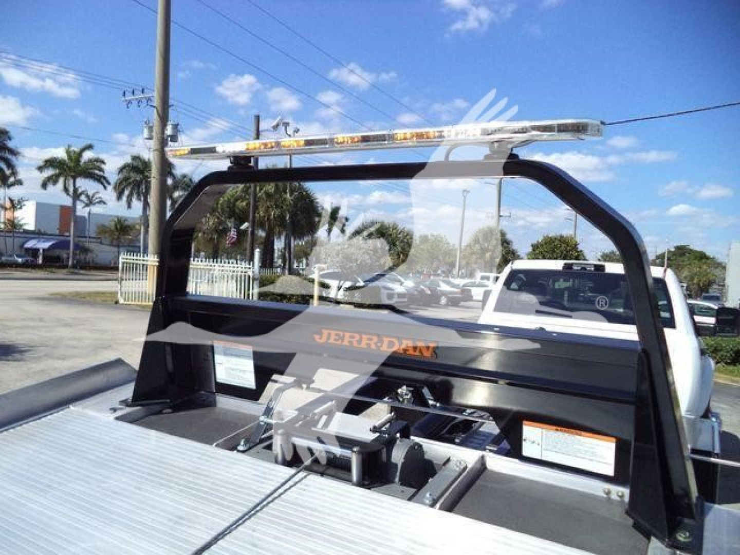 Ram 5500 rollback bed with Jerr-Dan logo and light bar mounted on a truck chassis; visible label information and equipment in bed area.