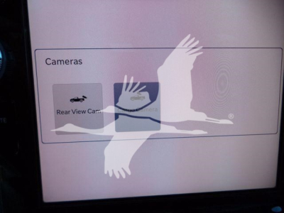 Ram 5500 Big Horn rollback truck interior screen showing cameras option and rear view camera label.