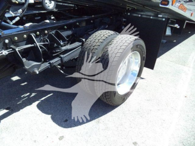 Ram 5500 rollback truck rear wheel and chassis in-service view showing suspension and tire details.