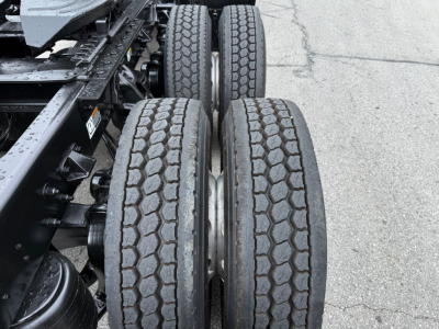 Kenworth T880 chassis with dual rear axles and treaded tires showing wheel rims and undercarriage components.
