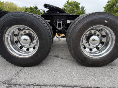 Kenworth T880 wheel assemblies showing dual rear tires and chrome hubs with reflective caps.