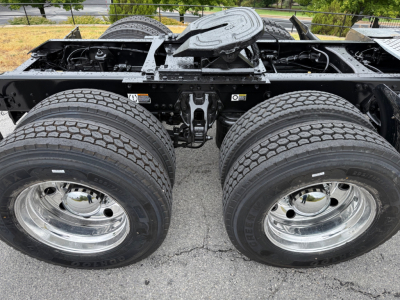 Dual rear axles on a Kenworth truck chassis with visible tires and wheel rims; no additional readable text.