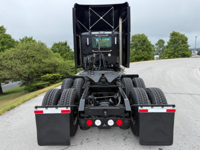 Kenworth T880 rear view showing fifth wheel, dual rear axles, mud flaps, and rear lights with stock number plate; chassis and cab visible.