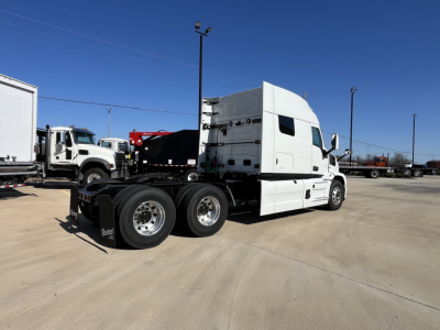 2026 Mack PR64T76M truck cab and chassis side view showing sleeper cab, three rear axles, white exterior, no visible damage.