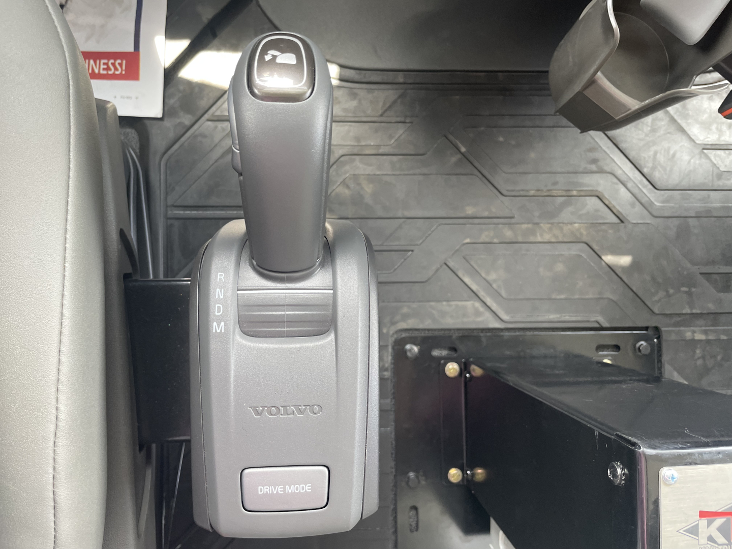 Volvo truck gear shifter and drive mode control in cabin viewing R-N-D-M gear indicator and Volvo logo.