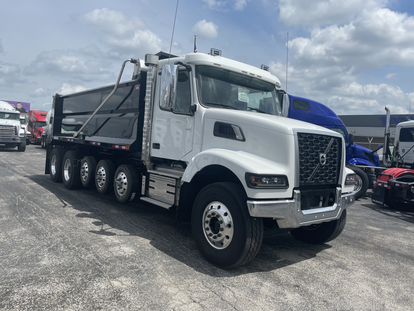 Volvo VHD64F300 dump truck with side view showing cabin and dump bed. No visible text on door or panels.