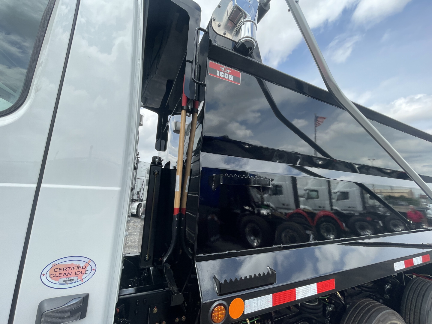 Volvo VHD64F300 dump truck side panel with ICON hydraulic system label andCertification sticker visible.