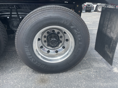 Volvo VHD64F300 truck wheel and tire showing M+S tire brand with steel rim and hub, under-carriage components visible.