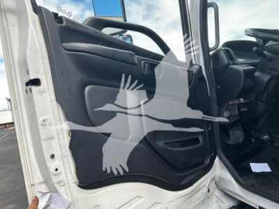 Truck cab interior door panel and open driver-side door of a 2020 Hino 268A, with visible steering wheel and dashboard area.