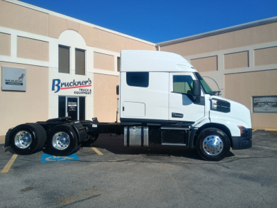 Truck chassis with cab in front of a building; signage reads Mack and Brockner's Truck & Equipment branding.