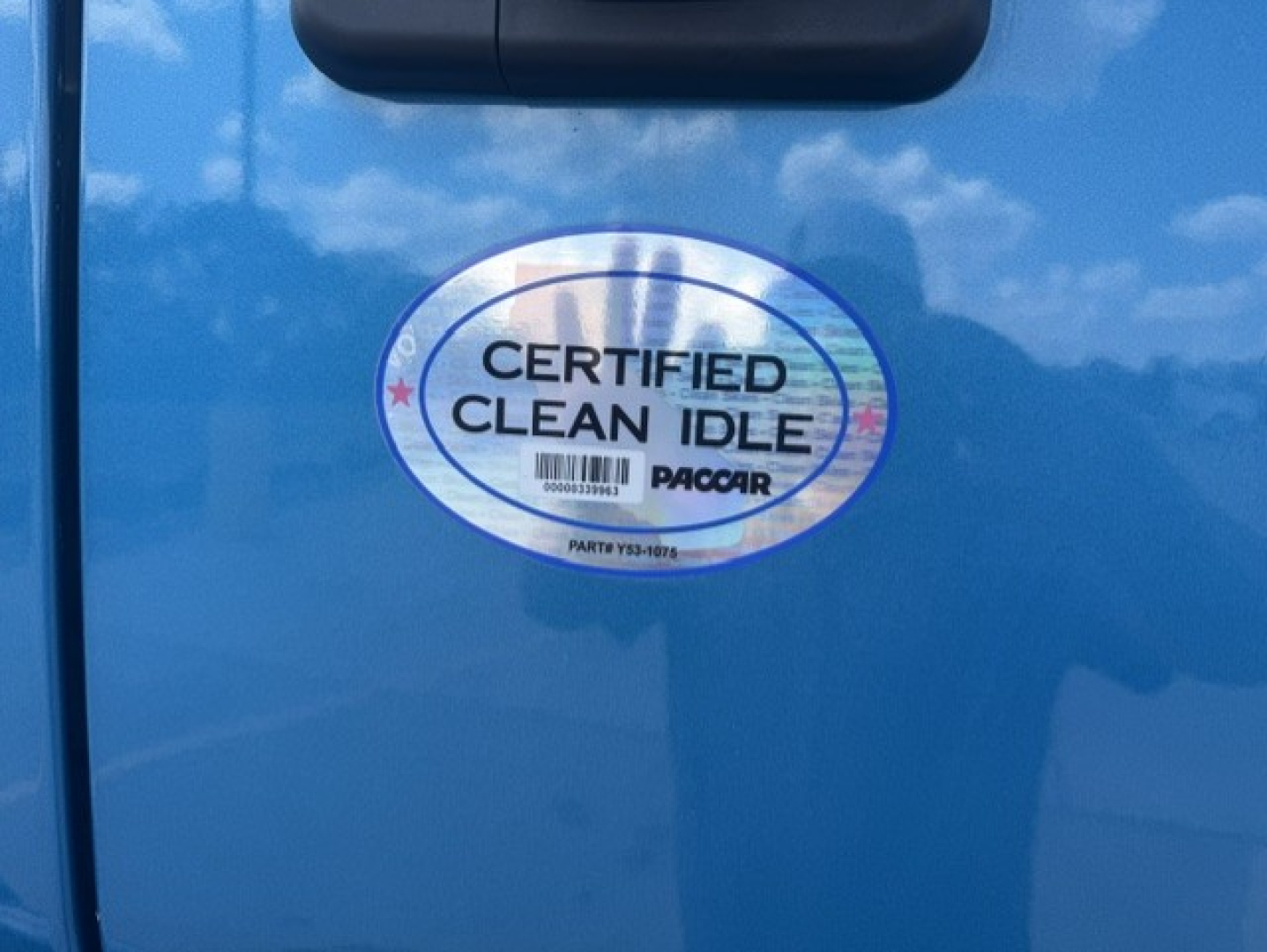 Peterbilt 579 cab door with Certified Clean Idle PACCAR sticker visible.