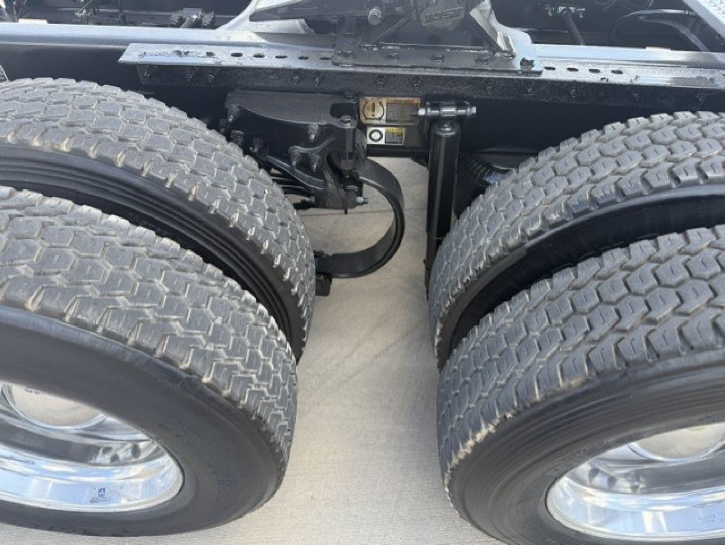 Peterbilt truck dual rear axles undercarriage with suspension components and wheels visible.