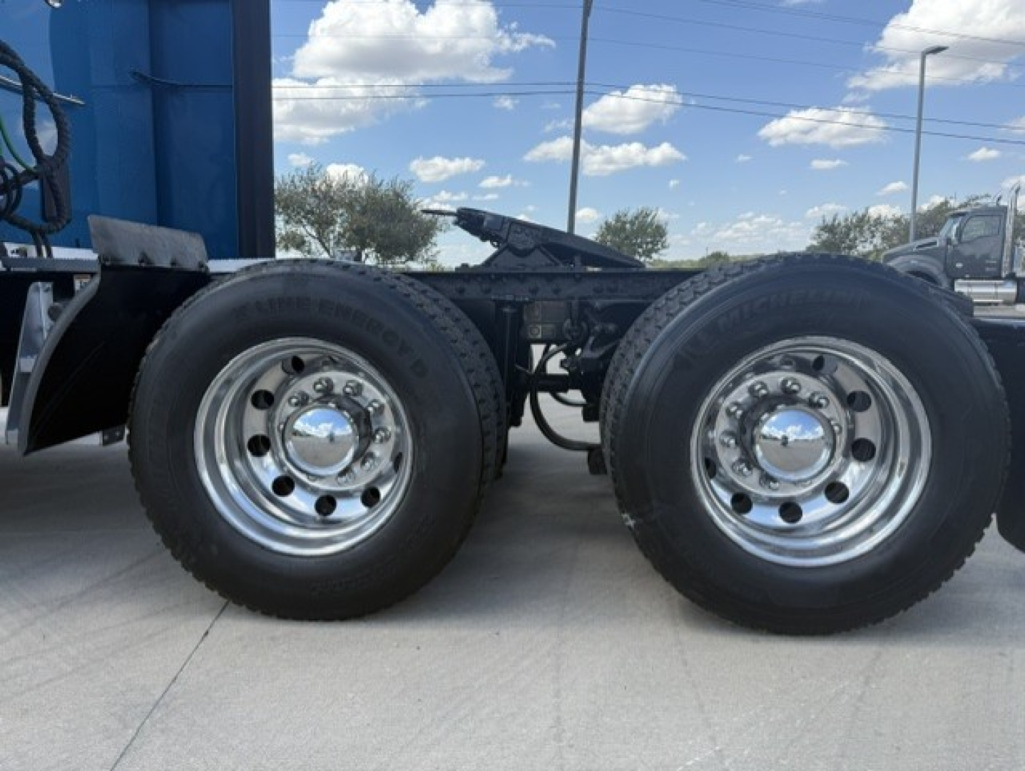 Peterbilt 579 chassis dual rear wheels showing chrome hubcaps and tires.