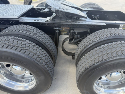 Peterbilt 579 truck chassis showing dual rear axles and suspension with tires and rims visible.