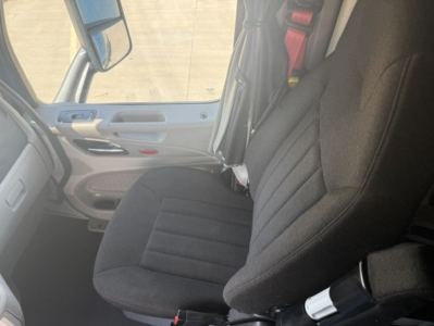 Peterbilt 579 interior front seat view with driver seat and door panel visible.