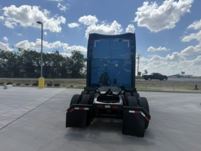 Peterbilt 579 tractor rear view showing fifth wheel hitch and dual rear axle with mud flaps