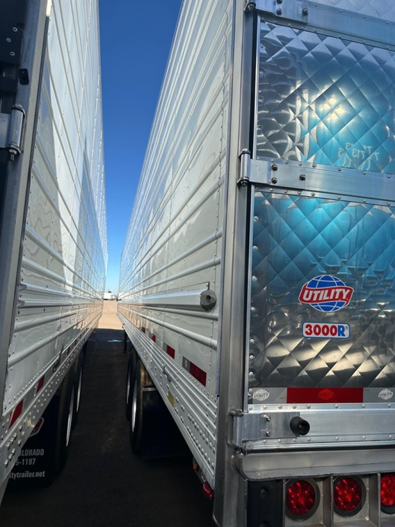 Reefer trailer doors and reflective diamond-plate rear showing Utility 3000R logo and bumper lights.