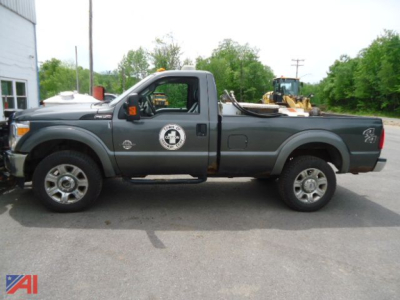 Ford F-350 Super Duty pickup with plow in serviceable condition showing side profile and service logo on door.