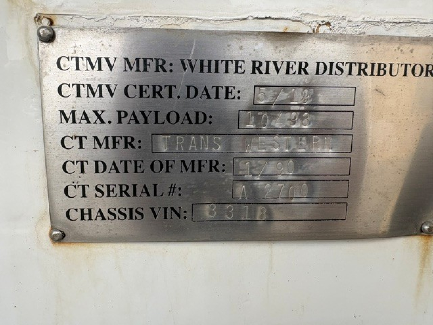 Metal data plate on a 2016 Ford F-750 showing CTMV MFR: White River Distributors, CTMV CERT. DATE: 6/23, MAX PAYLOAD: 10,?8, CT MFR: Trans Master, CT DATE OF MFR: 12/08, CT SERIAL #: LA7710, CHASSIS VIN: 1FDXF7DCXGDA03318