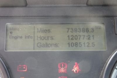 Vehicle dashboard display showing Miles: 738,386.3, Hours: 12,077.21, Gallons: 1,08512.5 with warning indicators below.