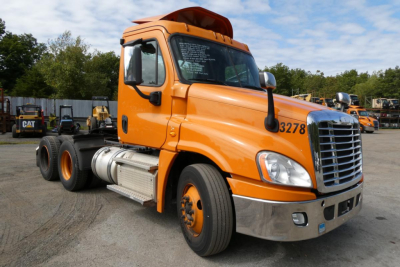 Orange Freightliner Cascadia 125 daycab truck in a lot, side view showing cab and chassis with number 3278