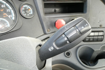 Truck steering column with gear shifter in D R position and dashboard gauges visible