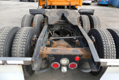 Rear view of a freightliner cascadia 125 tractor showing the fifth wheel landing gear and dual rear axles with tires.