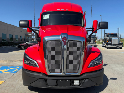Front view of a red Kenworth T680 truck. The grille and emblem are visible; side mirrors and headlights; large bumper area. Text not legible in image beyond truck branding.