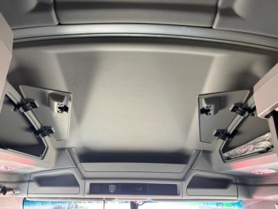 Interior overhead panel of a 2023 Kenworth T680 sleeper truck showing storage compartments and ceiling panels.