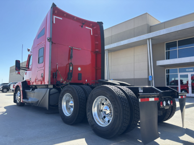 Kenworth T680 truck rear and side view showing dual rear axle/sets with red cab and chrome wheels. Visible text includes no obvious labels in view.