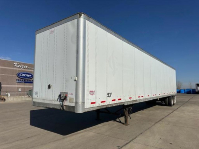 Trailer side view showing 53' box, white aluminum exterior, rear doors, leg stand, and dual rear axles.