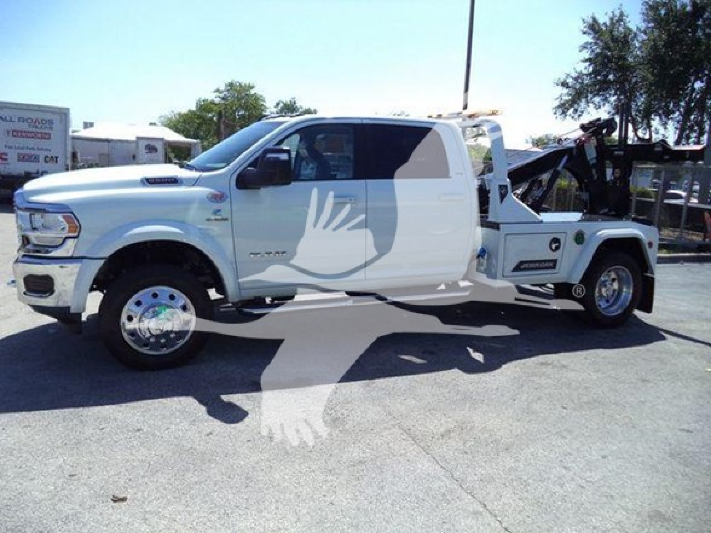 RAM Ram 2500/3500 pickup with white body, dual cab, lifter/winch equipment in bed, side view showing front and rear wheels.