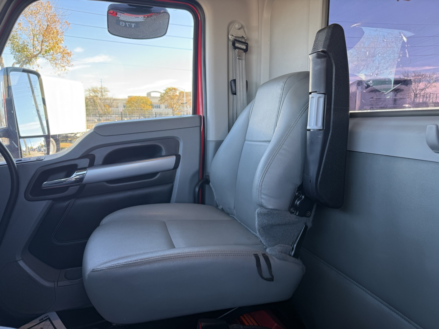 Truck cab interior showing seats and door panel of a 2020 Kenworth T880 conventional daycab.