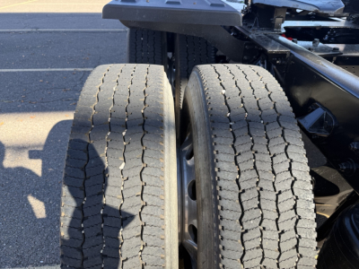 Dual rear wheels of a 2020 Kenworth T880 truck chassis with visible tires and suspension components.