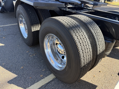 Kenworth T880 chassis showing dual rear axles with chrome wheels and dual tires.