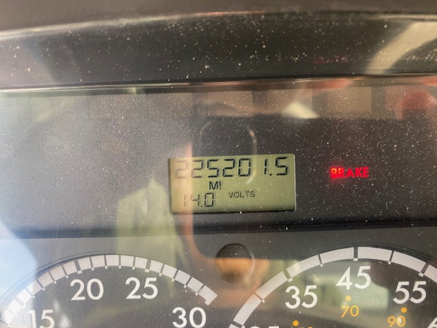 Freightliner M2-112 dashboard showing odometer and dash gauge with warning BRAKE illuminated and digital display reading 23520.1.5 miles and 140 volts.