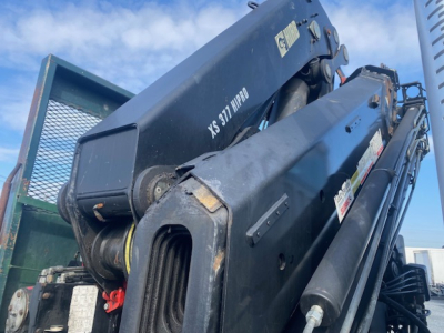 Crane truck boom and hydraulic components on a Freightliner M2-112 with XS 317 HPRO label visible.