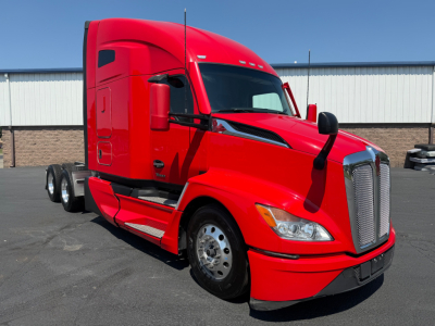 Kenworth T680 conventional sleeper truck in red, front-left view with dual rear axles and large chrome grille, no visible text on decals.