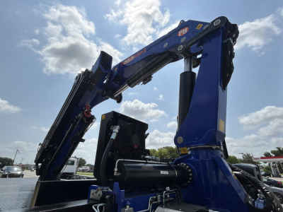 Mack GR64F crane truck arm and hydraulic cylinders in blue with black components, side view showing hydraulic hoses and joints.