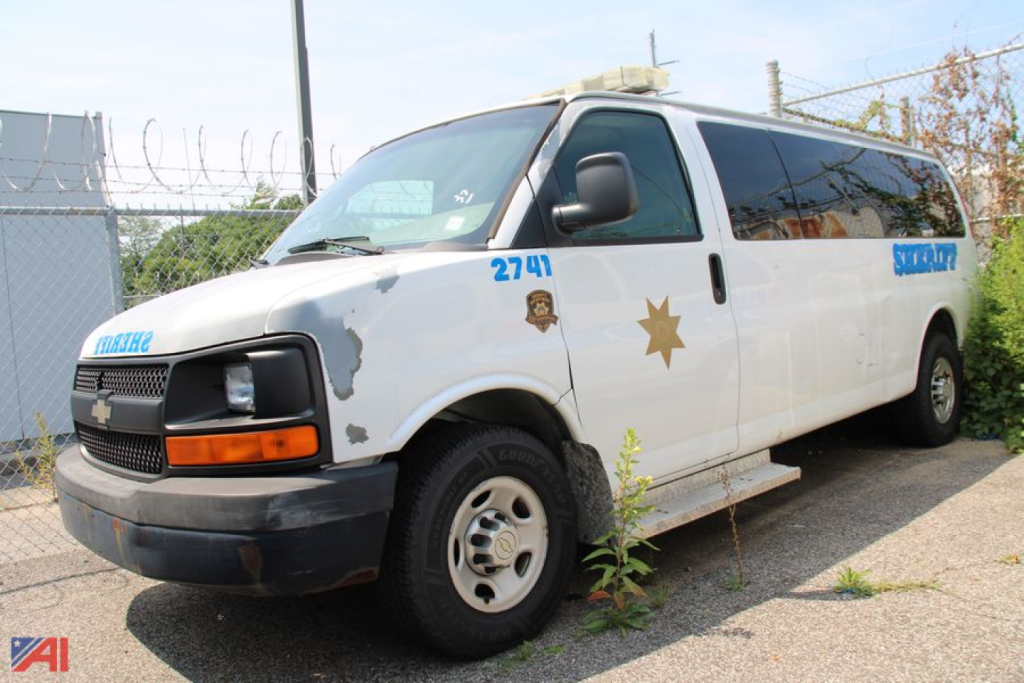 Chevrolet Express LS 3500 passenger van in light color with police/park ranger markings, front three-quarter view.