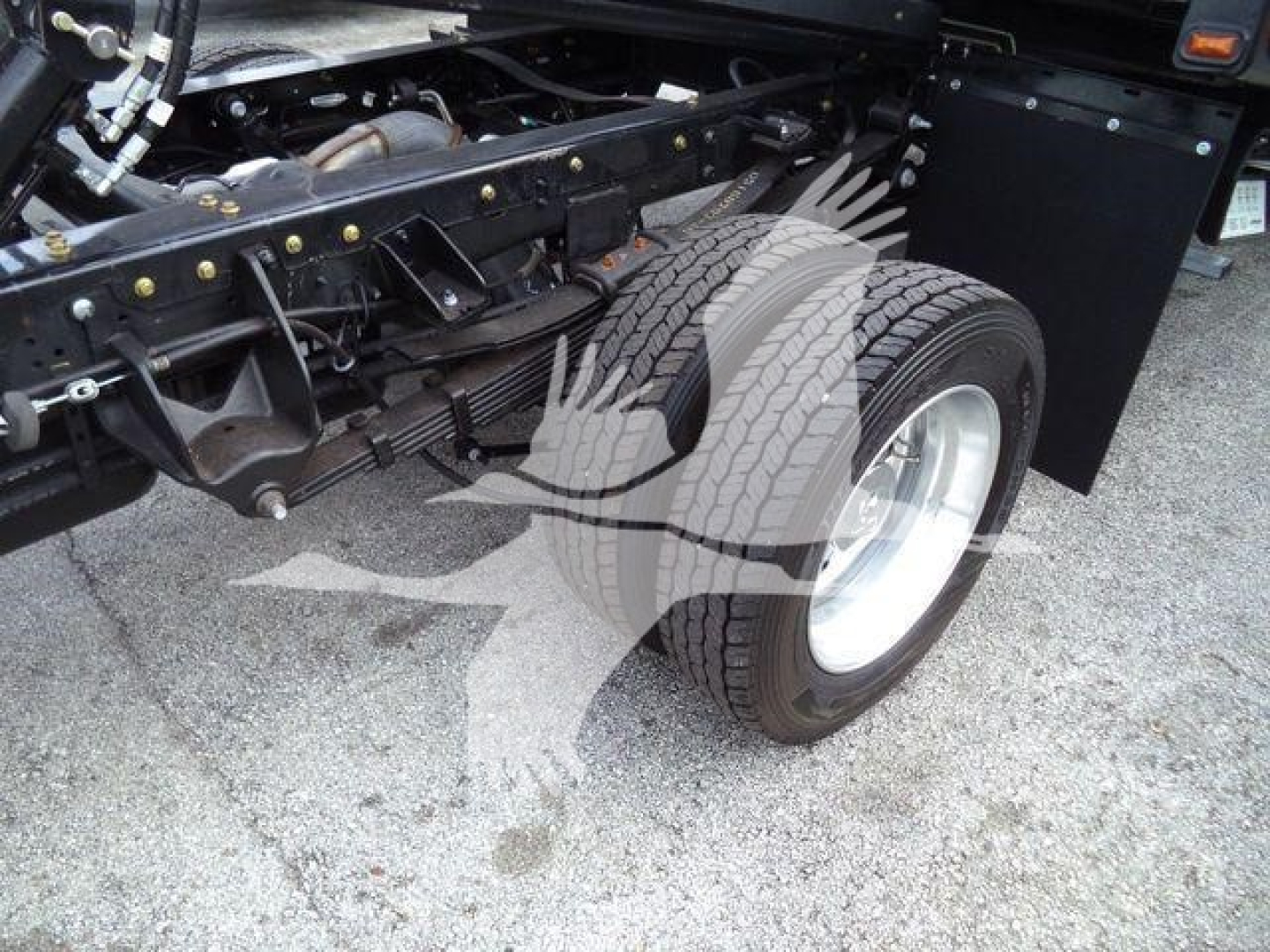 Ram 5500 rollback truck rear suspension and dual rear wheels showing solid frame and tire treads.