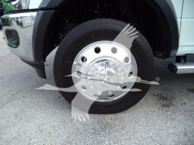 Ram 5500 front wheel showing chrome hubcap and tire, light-colored body panel, fender, and part of wheel well visible.