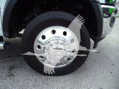 Ram 5500 front wheel and chrome hubcap showing wheel well